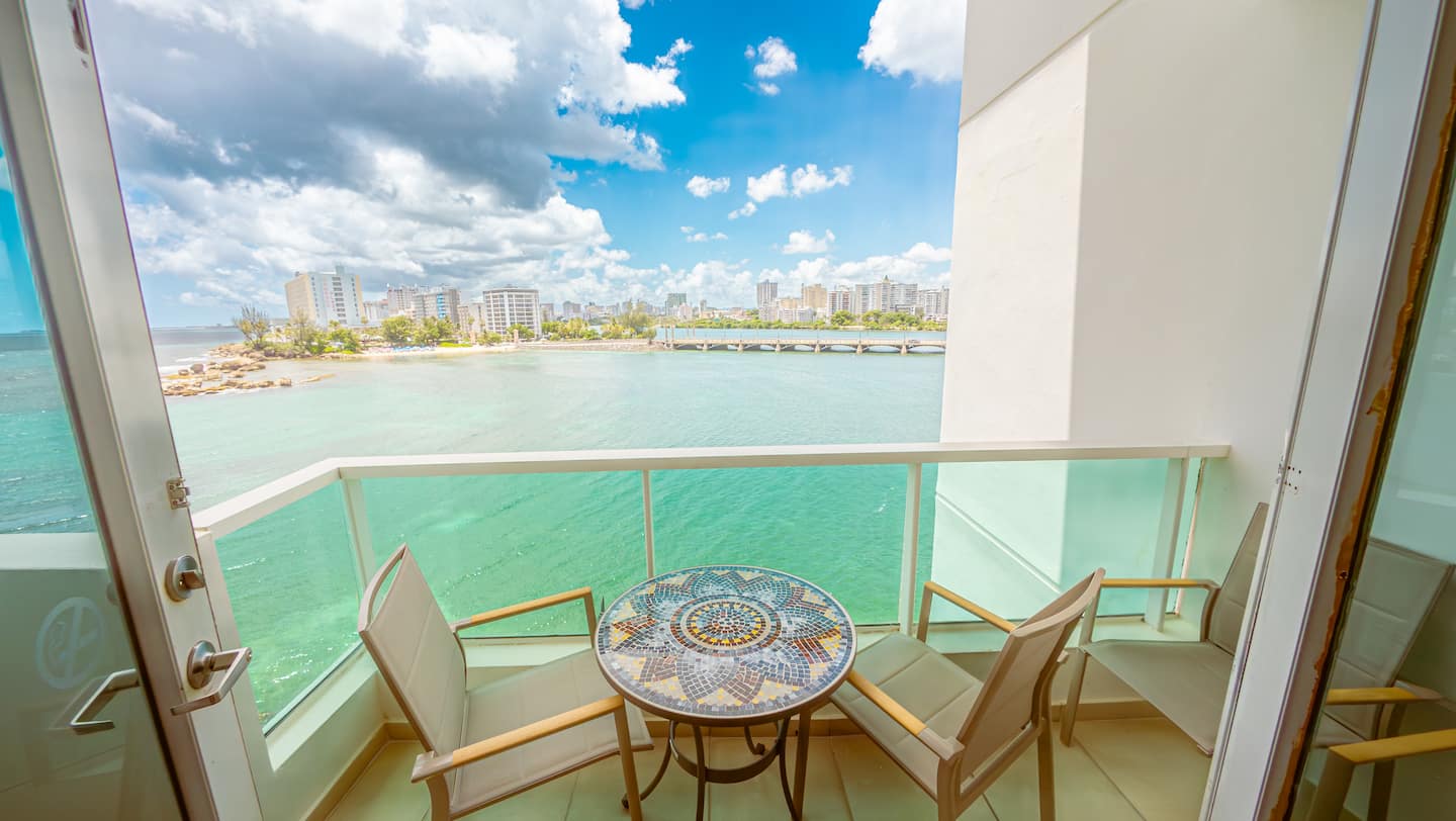 Balcony table set for two overlooking Condado Lagoon