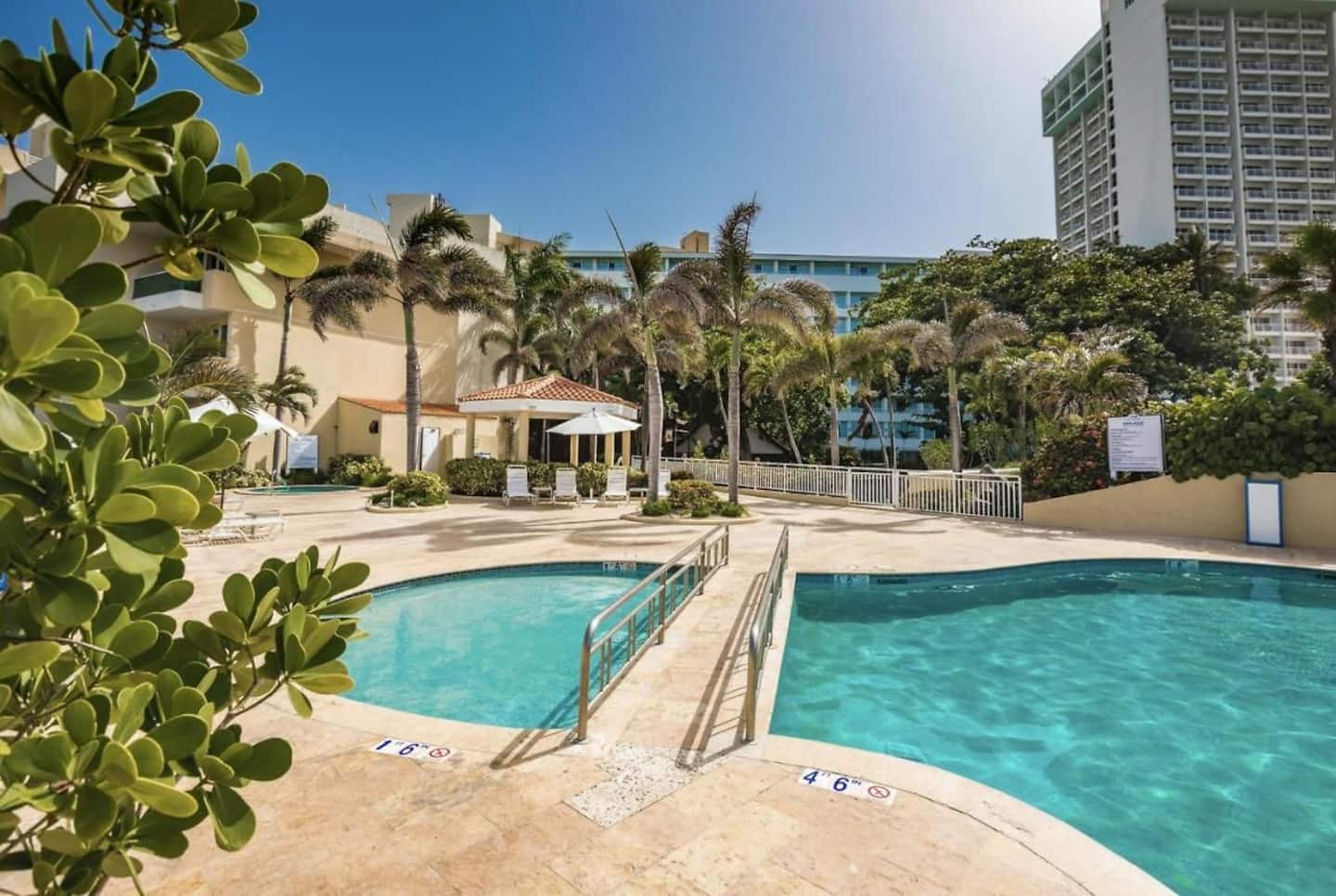 Pool at Condado Lagoon Villas with the lagoon behind it