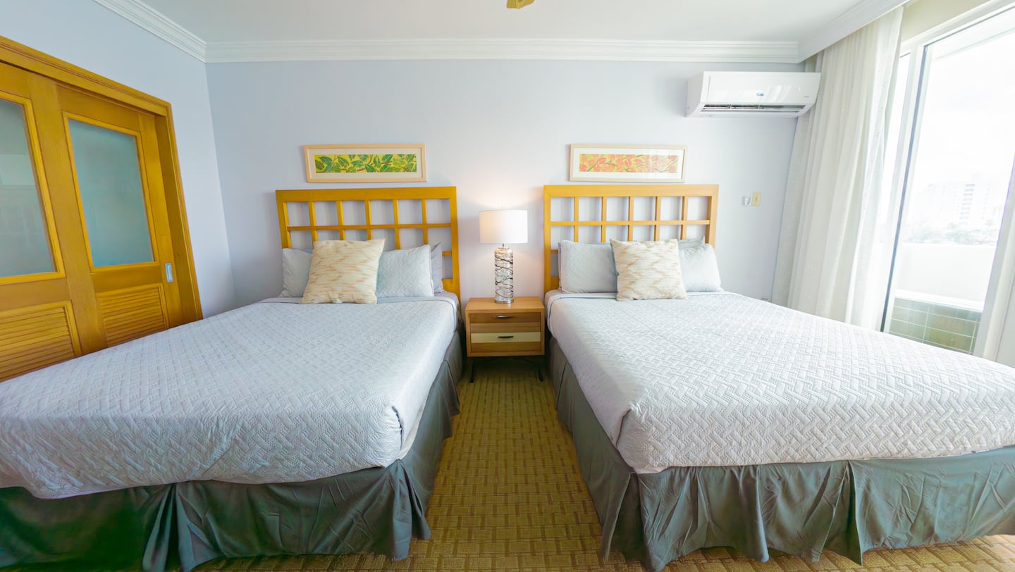 Suite 510 with two queen beds and a balcony over the lagoon